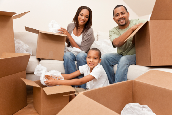 African American Family Unpacking Boxes Moving House