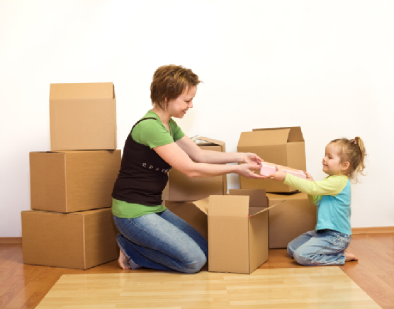 Woman and little girl in a new home unpacking